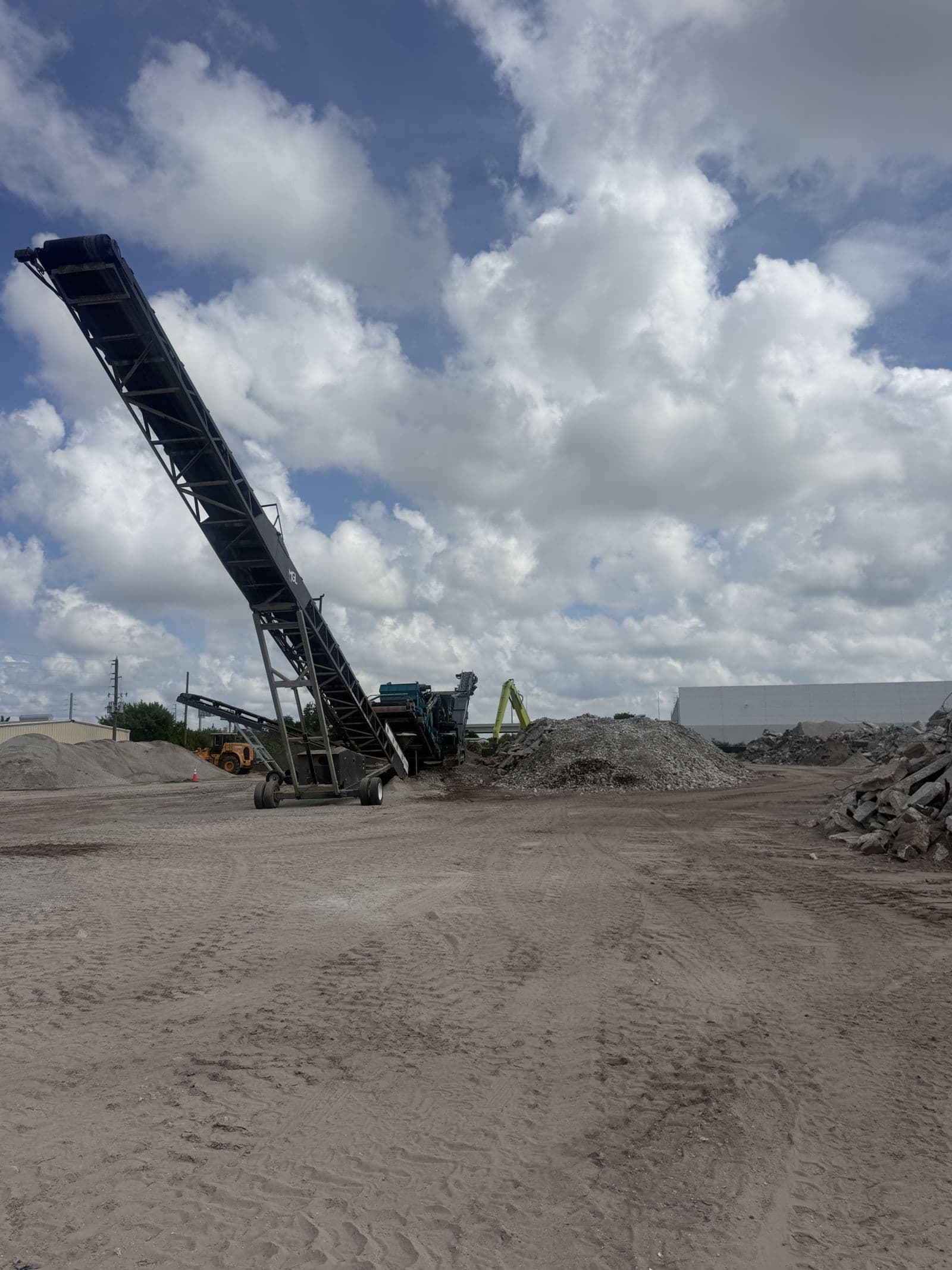 Recycled aggregate stockpiles and a radial stacker at the ATLAS Clearwater yard